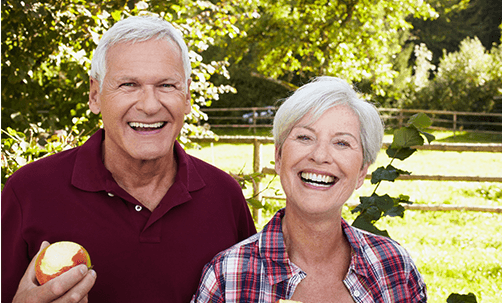 Older couple enjoying apples outdoors